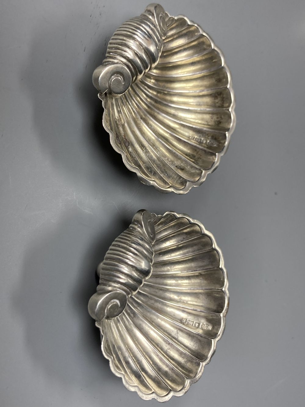 A pair of modern silver candlesticks, 15.6cm, weighted, a pair of George V silver shell salts and six coffee spoons